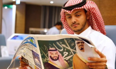 Photo of a man reading a newspaper in Mecca, Saudi Arabia