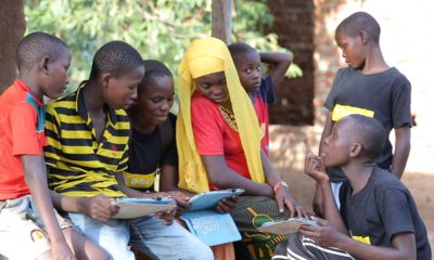 Photo of children fathering to learn from tablets