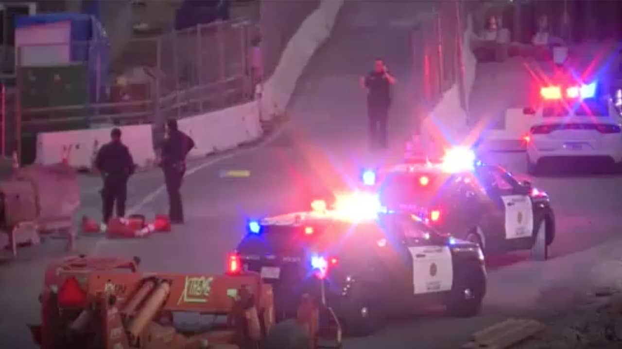 Screenshot of police officers and border agents at the California-Mexico border