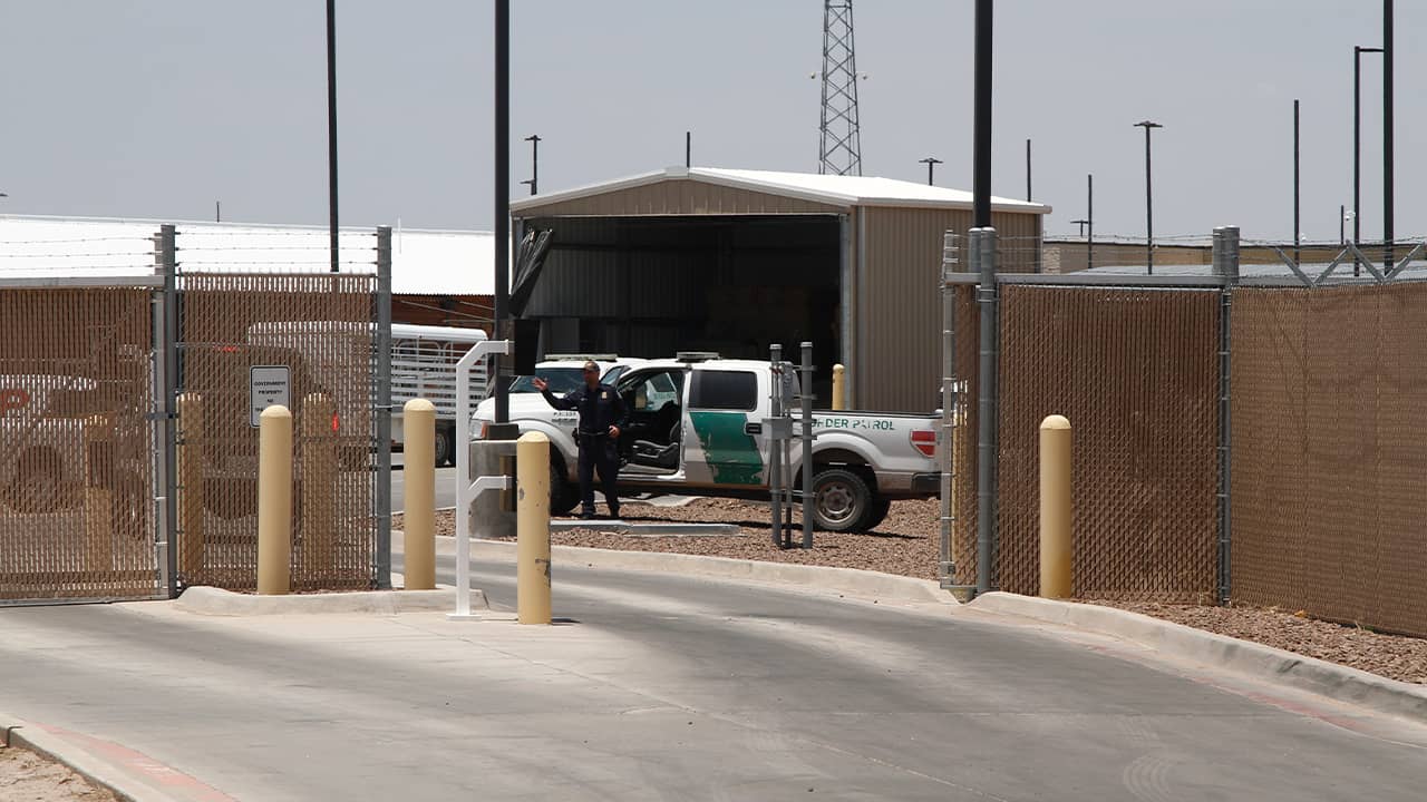 Photo of an officer guarding the entrance to the Border Patrol station in Clint, Tx.
