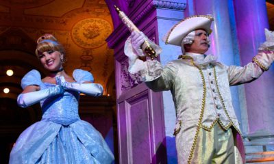 Photo of costumed Cinderella and Majordomo appear before guests