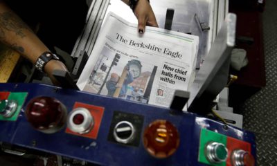 Photo of The Berkshire Eagle newspapers being placed in a machine