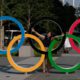 Photo of Tokyo resident taking a picture of his wife with the Olympic rings in Tokyo