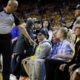 Photo of referee Marc Davis gestures toward Warrior investor Mark Stevens