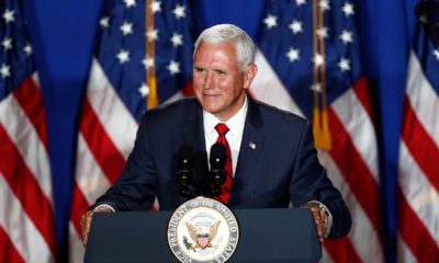Photo of VP Mike Pence in front of American flags