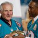 Miami Dolphins player Nick Buoniconti (85) is presented a football by former player and current Dolphins senior vice president of special projects and alumni relations, Nat Moore