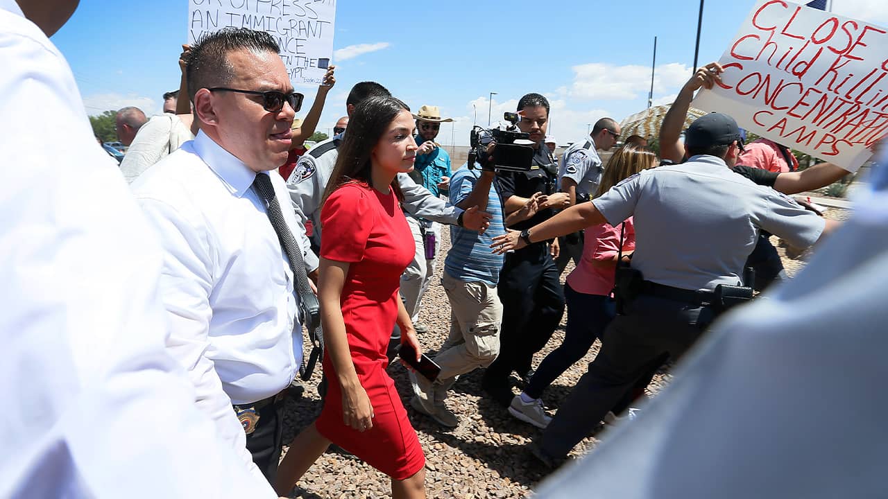 Rep. Alexandria Ocasio-Cortez being escorted after touring the Border Patrol station in Clint, Tx.