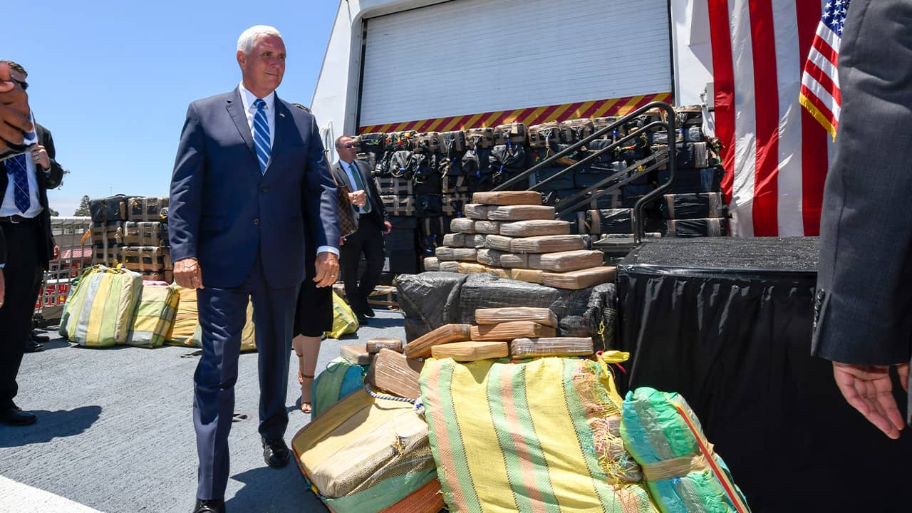 Photo of VP Mike Pence and bales of seized cocaine