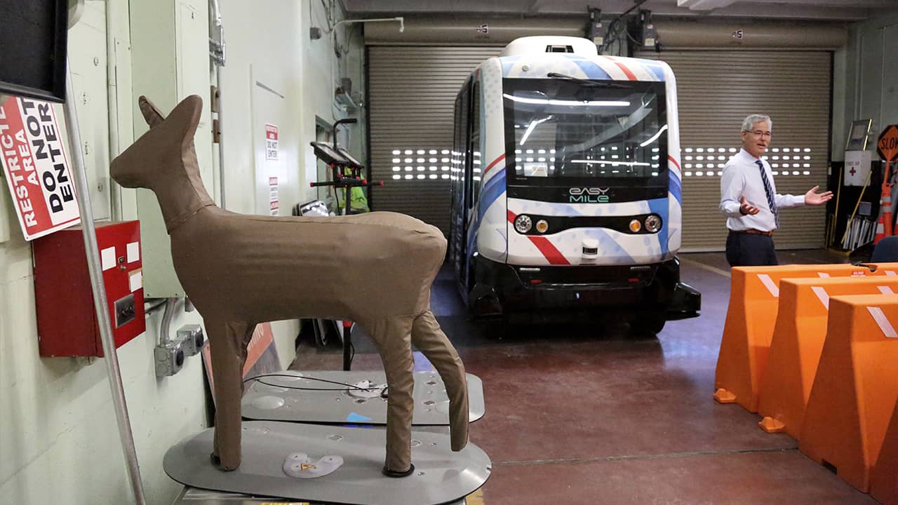 Photo of Randy Iwasaki with an autonomous bus