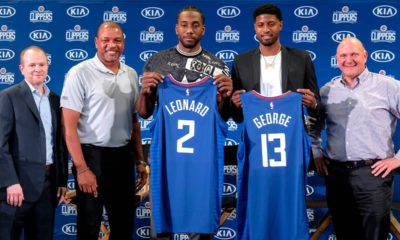 Photo of Kawhi Leonard, center, and Paul George, second right, holding their new team jerseys, with Los Angeles Clippers President of Basketball Operations Lawrence Frank, left, head coach Doc Rivers, second left, and team chairman Steve Ballmer