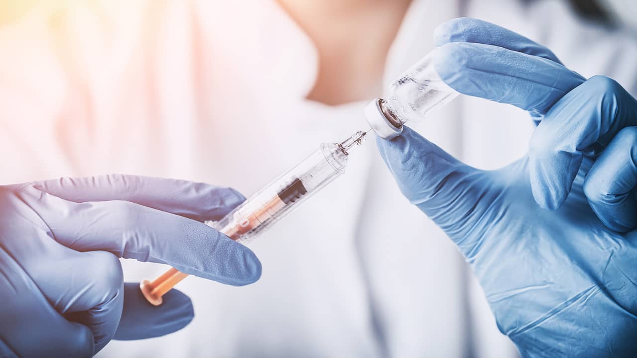 Photo of a doctor with a vaccine