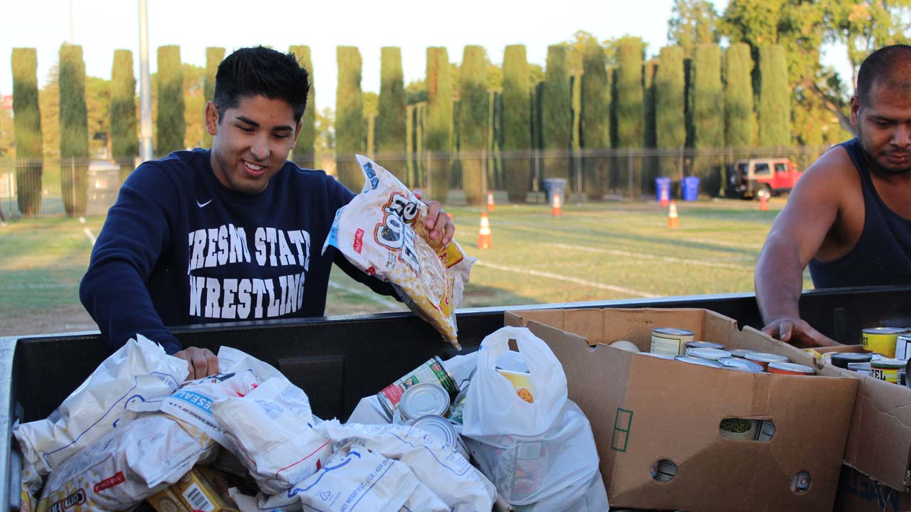 Photo of Fresno State students help out during the 2018 "Feed the Need" food drive for the Student Cupboard
