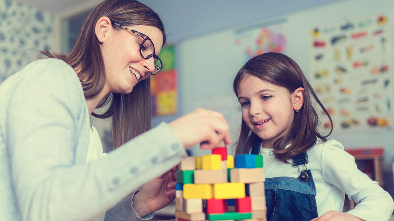 Photo of woman and child with building blocks