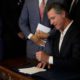 Photo of Gavin Newsom signing AB1482
