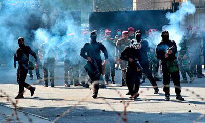 Photo of Iraqi security forces firing tear gas
