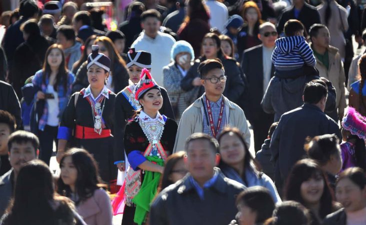 In this photo taken Dec. 26, 2016, thousands filled the fairgrounds for the first day of the Hmong International New Year in Fresno, Calif. The country's small Hmong American population is reeling from the shooting deaths of four men at a backyard party at a Northern California central valley city. Fresno hosts a week-long New Year's party every year that draws tens of thousands of Hmong from around the country, complete with colorful traditional dress, song, and sports games. (John Walker/The Fresno Bee via AP)