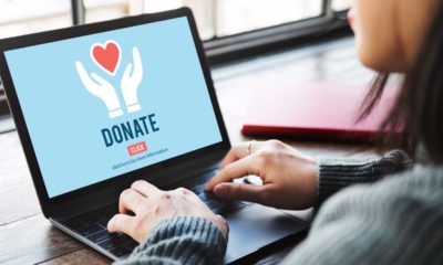 Photo of a woman at a laptop donating online