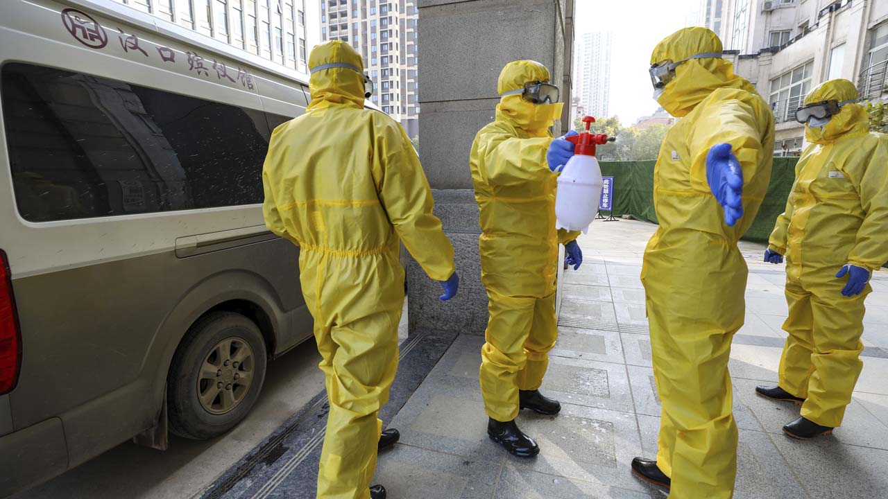 Photo of funeral workers disinfecting themselves