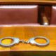 Photo of handcuffs on a court bench
