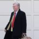 Photo of John Bolton leaving his house