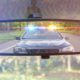 Photo of a cop car seen through a rear-view mirror