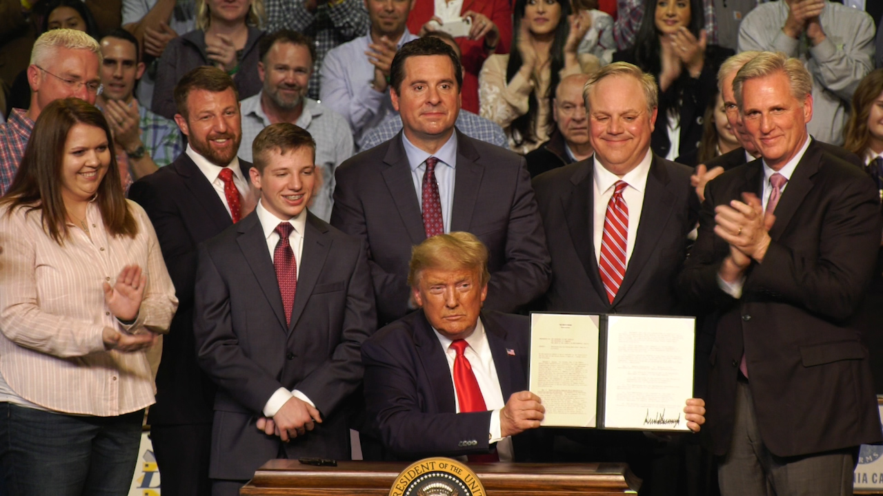 President Donald Trump signs water memo at Bakersfield rally.