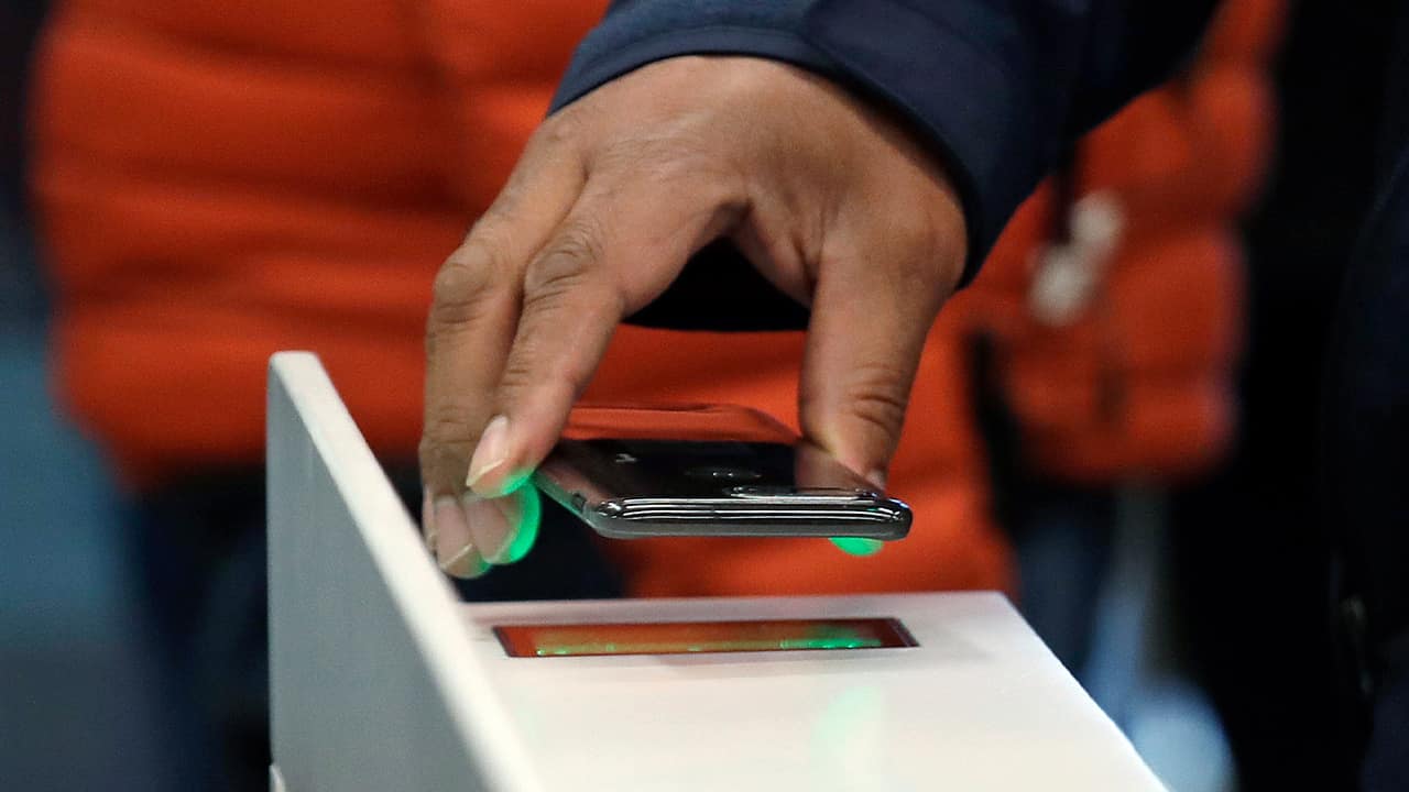 Photo of a shopper using an Amazon Go app