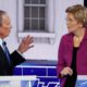 Photo of Democratic presidential candidate, former New York City Mayor Mike Bloomberg talking with Sen. Elizabeth Warren