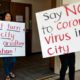 Photo of protesters holding signs in Costa Mesa, Calif.