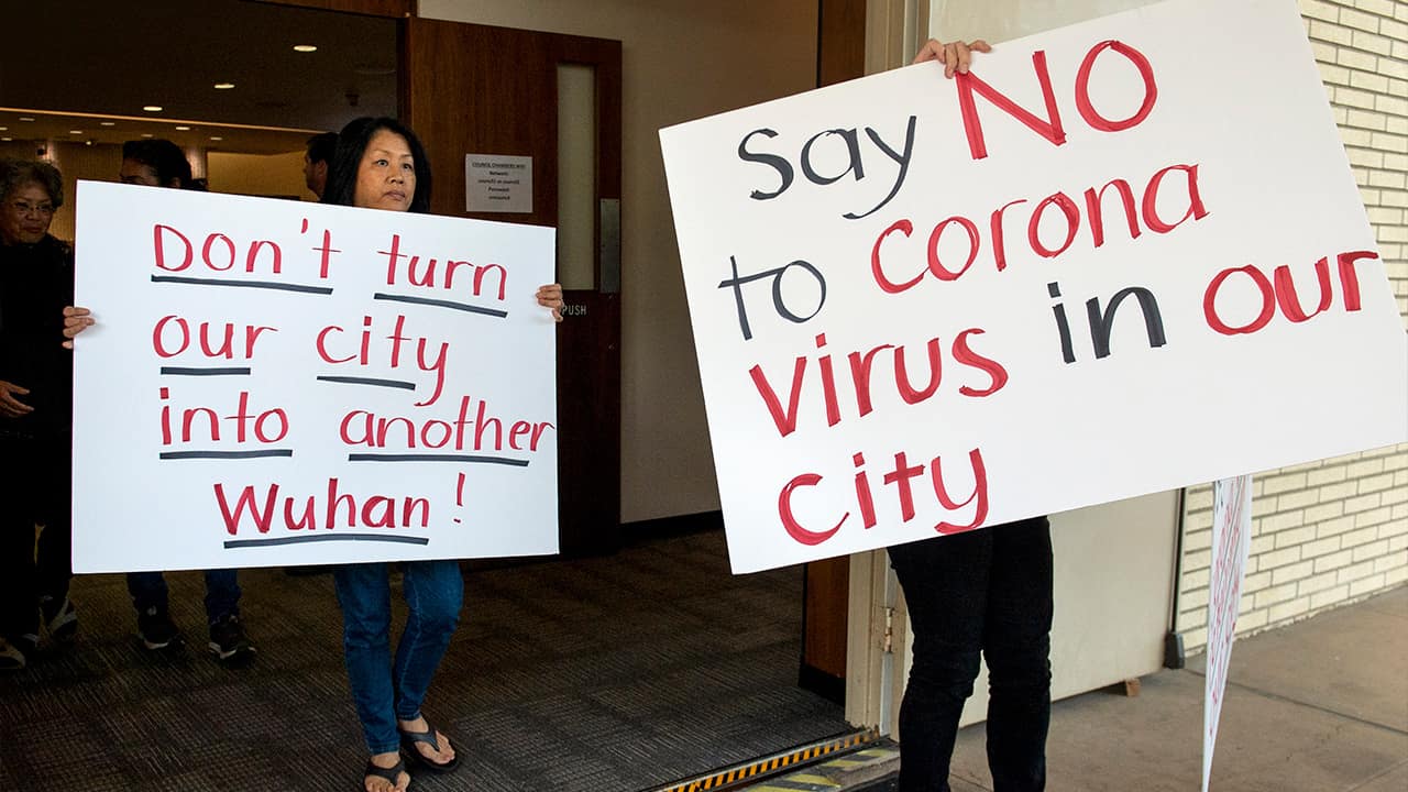 Photo of protesters holding signs in Costa Mesa, Calif.