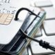 Photo illustration of a fishing hook snagging credit cards symbolizing theft and credit card fraud