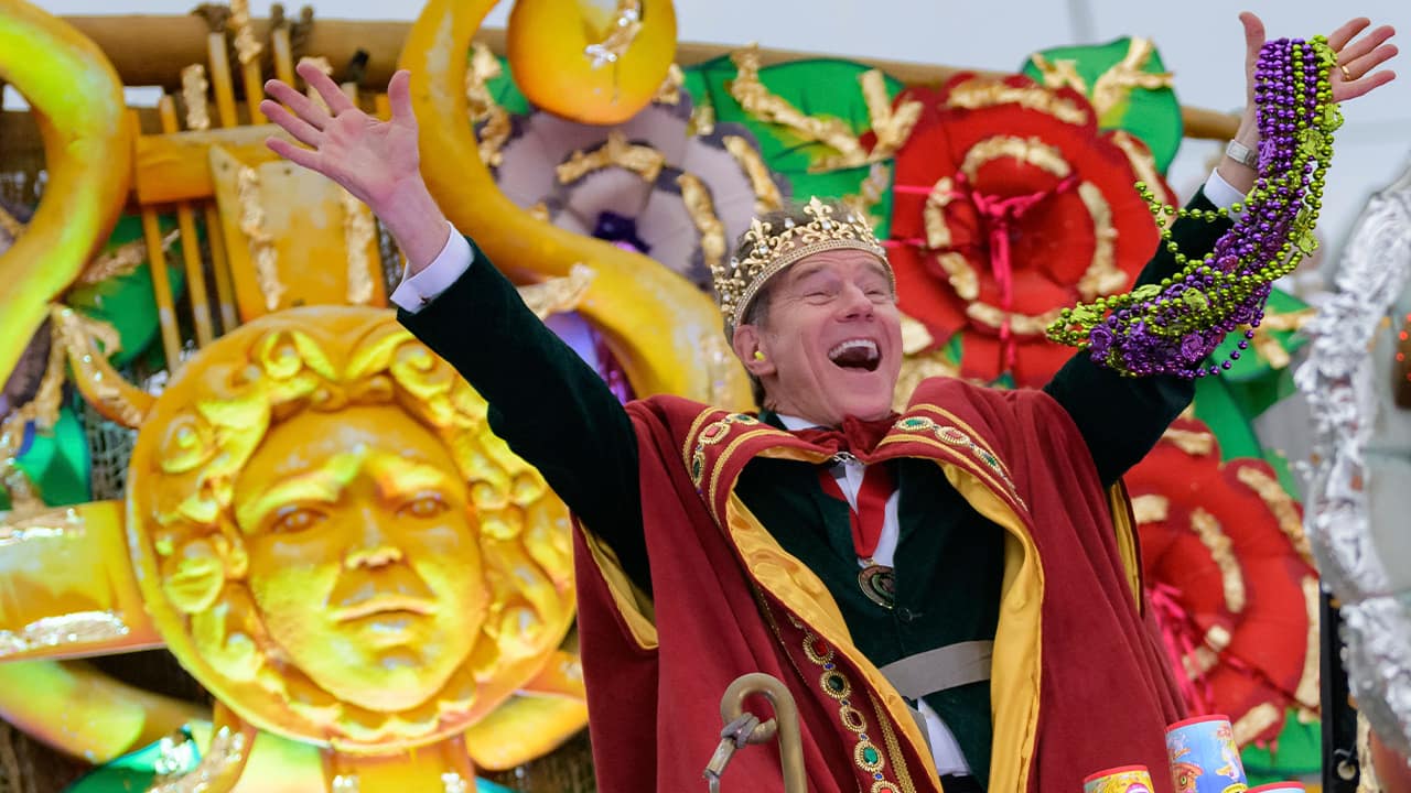 Photo of Actor Bryan Cranston waving beads