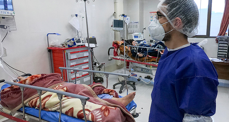 Photo of a nurse caring for a patient in Qom, Iran