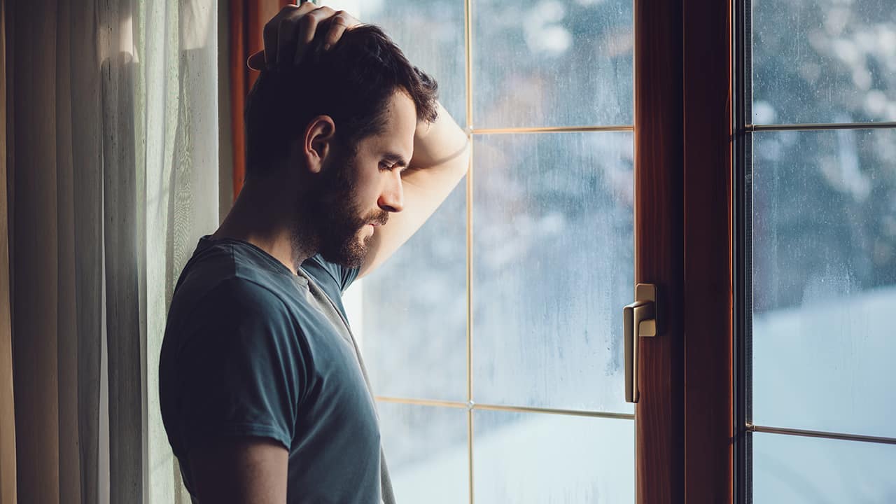 Photo of a man staring out the window