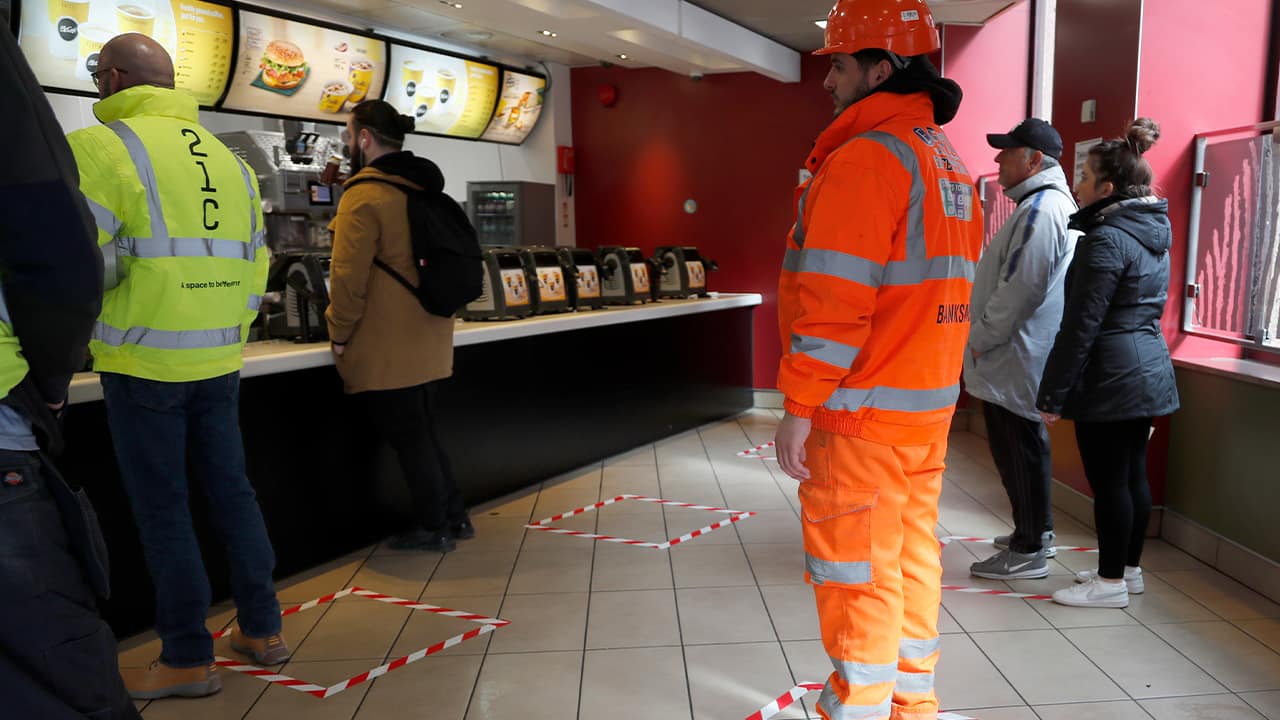 Photo of people standing in marked places