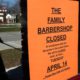 Photo of a man walking by a closed sign