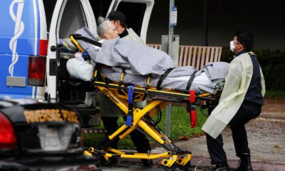 Photo of a patient being taken away from a nursing home