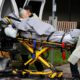 Photo of a patient being taken away from a nursing home