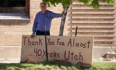 Photo of Scott Evans posing with a sign