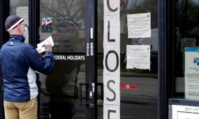 Photo of a man writing information in front of a security business