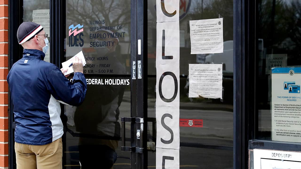 Photo of a man writing information in front of a security business