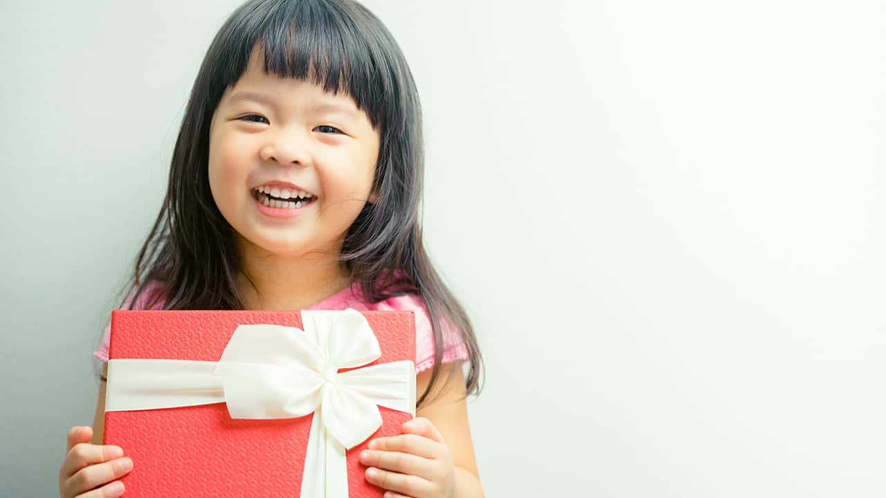 Photo of a child holding a present