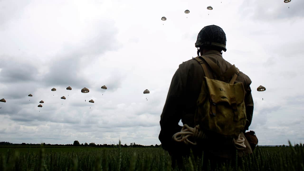 Photo of a man watching a parachute jump in France