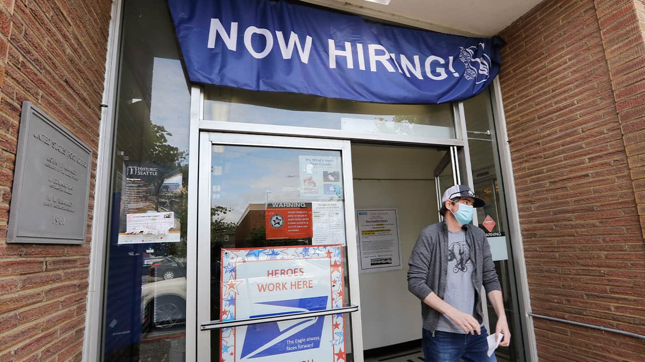 Photo of a man walking out of a post office