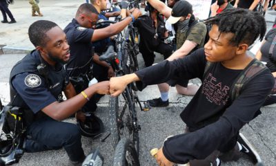 Photo of a police officer fist bumping a protester in Atlanta
