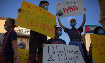 Photo of protesters holding signs