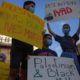 Photo of protesters holding signs