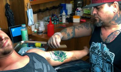 Photo of a man getting a tattoo covered up
