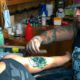 Photo of a man getting a tattoo covered up