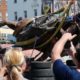 Photo of crews lowering a statue